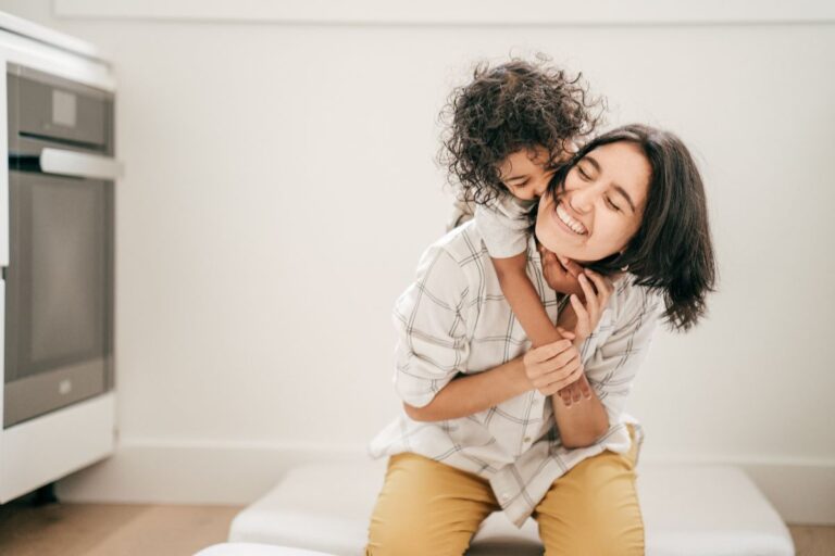 The Little Things Kids Remember, mom hugging a toddler in the kitchen