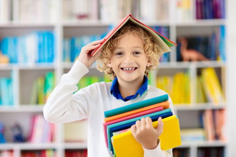 Preparing Kids for Change without Creating More Stress, young child playing with books on his head